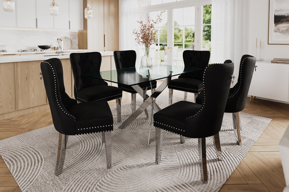 7-piece dining set with thick tempered glass table and cream, Black, grey velvet chairs featuring tufted backs, nailhead trim, and chrome legs.