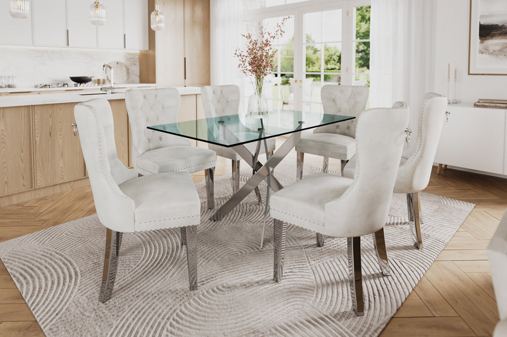7-piece dining set with thick tempered glass table and cream, Black, grey velvet chairs featuring tufted backs, nailhead trim, and chrome legs.