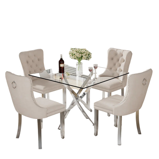 5-piece dining set with thick tempered glass table and cream, Black, grey velvet chairs featuring tufted backs, nailhead trim, and chrome legs.