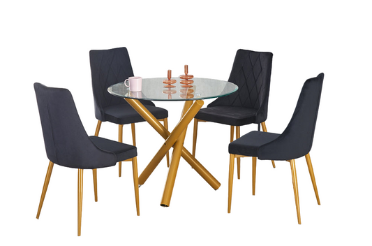 Modern round glass dining table with brushed gold legs and velvet/leatherette chairs in black, blue, and white colors.